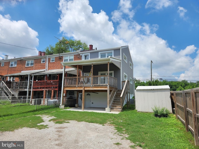 9765 Bird Riv, Middle River, MD 21220 - rear view of house with stairs, a fenced backyard, a storage unit, and a patio area