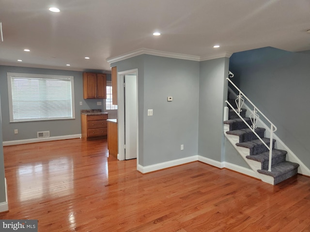 9765 Bird Riv, Middle River, MD 21220 - unfurnished living room featuring crown molding, stairway, light wood-style flooring, and recessed lighting