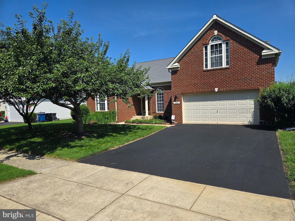 135 Walnut St, Ridgely, MD 21660 - traditional-style house featuring brick siding, driveway, an attached garage, and a front yard
