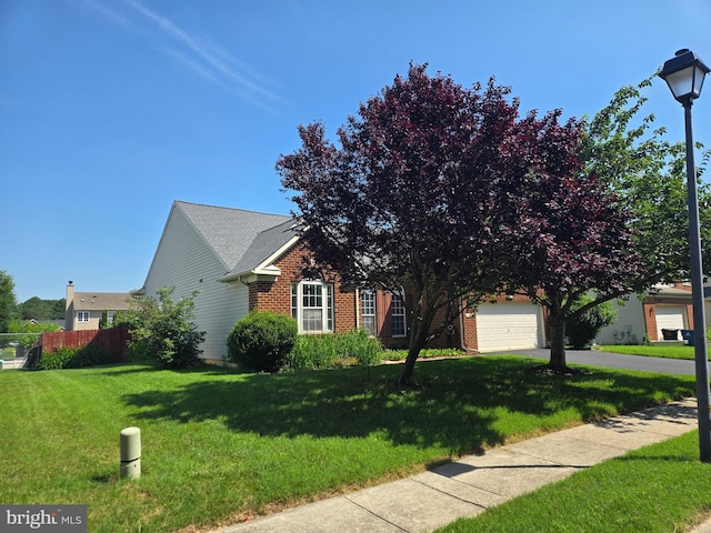 135 Walnut St, Ridgely, MD 21660 - view of property hidden behind natural elements featuring brick siding, driveway, and an attached garage
