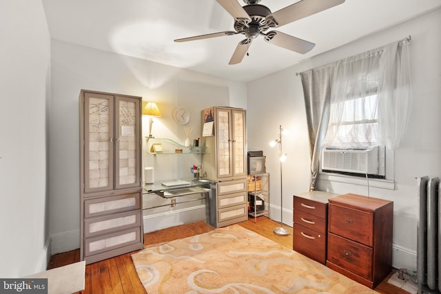 2515 17th St NE, Washington, DC 20018 - bedroom with radiator, light wood-type flooring, an office area, and ceiling fan