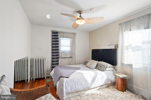 2515 17th St NE, Washington, DC 20018 - bedroom with radiator, wood finished floors, and ceiling fan