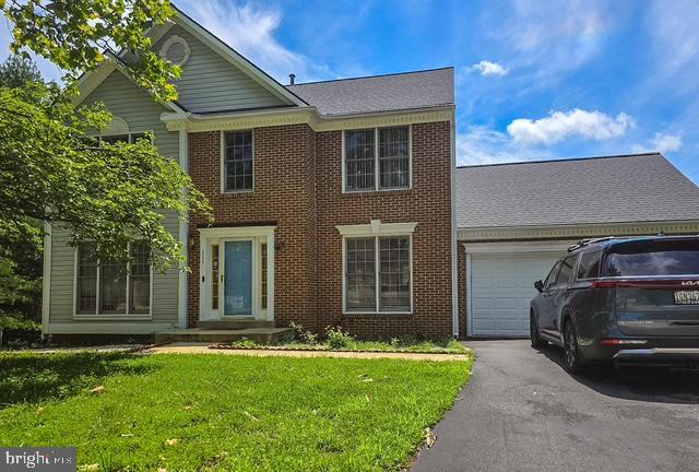 315 Johnsberg Ln, Bowie, MD 20721 - view of front facade with a garage, brick siding, a front lawn, and driveway