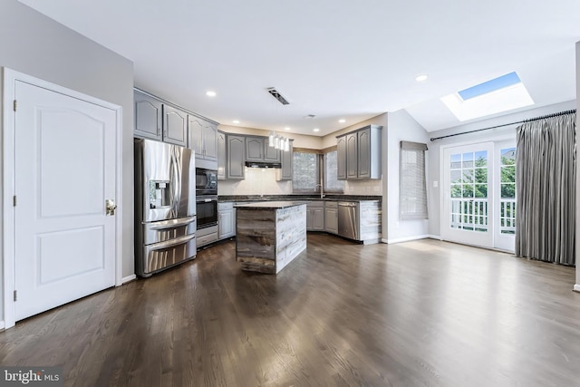 20152 Boxwood Pl, Ashburn, VA 20147 - kitchen with black appliances, gray cabinets, a skylight, dark countertops, and a kitchen island
