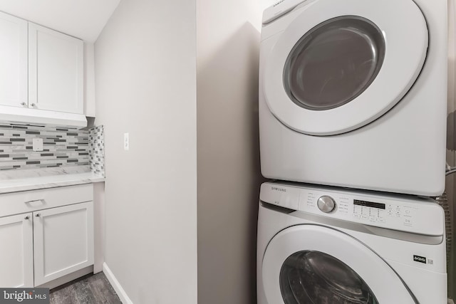 20152 Boxwood Pl, Ashburn, VA 20147 - laundry room featuring estacked washer and dryer, cabinet space, and wood finished floors