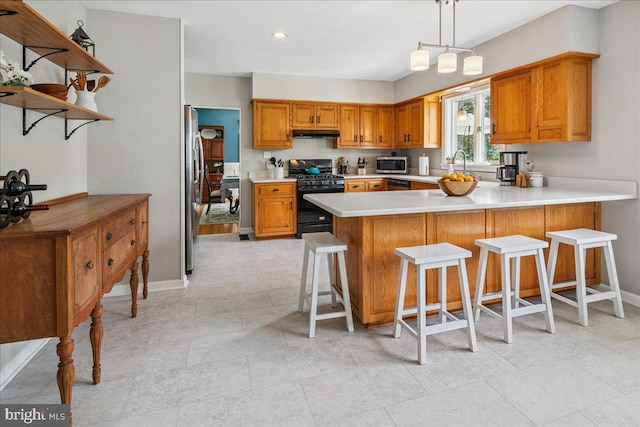 8 High Acres Dr, Ewing, NJ 08628 - kitchen with appliances with stainless steel finishes, under cabinet range hood, a peninsula, light countertops, and brown cabinets