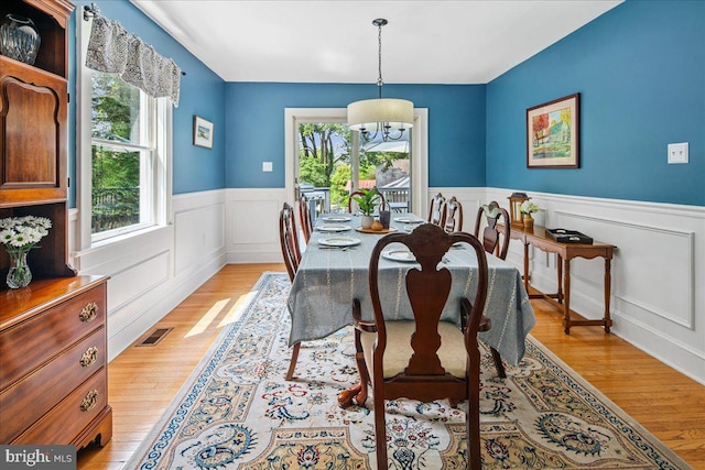 8 High Acres Dr, Ewing, NJ 08628 - dining space featuring a chandelier, light wood-type flooring, wainscoting, and a decorative wall