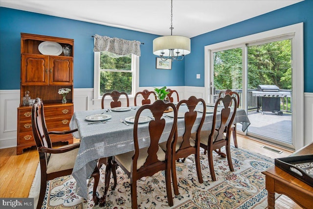 8 High Acres Dr, Ewing, NJ 08628 - dining area featuring a wainscoted wall, a chandelier, light wood-style floors, and a decorative wall