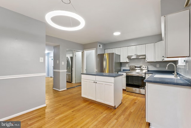 4 Habersham Ct, Silver Spring, MD 20906 - kitchen featuring appliances with stainless steel finishes, under cabinet range hood, dark countertops, white cabinets, and light wood-style floors