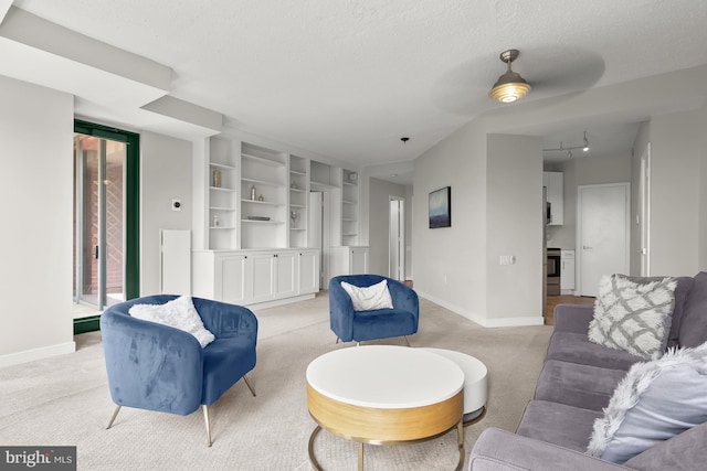 955 26th St NW Unit 510, Washington, DC 20037 - living room with light colored carpet, a textured ceiling, and built in shelves