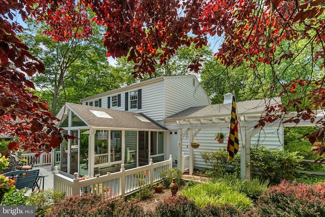 6162 Commadore Ct, Columbia, MD 21045 - rear view of house with a sunroom, a shingled roof, and a chimney