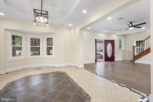 1432 Frush Valley Rd, Reading, PA 19605 - entrance foyer featuring a tray ceiling, recessed lighting, inlaid floor details, a ceiling fan, and stairs