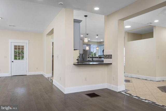 1432 Frush Valley Rd, Reading, PA 19605 - kitchen with decorative backsplash, dark countertops, wood finished floors, recessed lighting, and pendant lighting