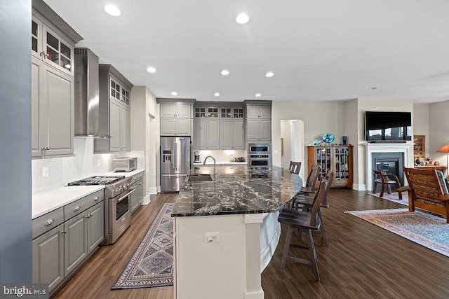 374 Lively Stream Way, Gettysburg, PA 17325 - kitchen featuring stainless steel appliances, gray cabinets, wall chimney range hood, dark wood-type flooring, and a large island