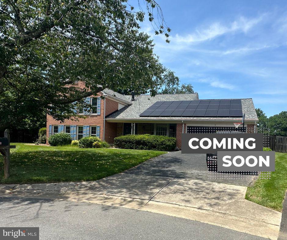 6 Thorburn Ct, Gaithersburg, MD 20878 - view of front of property featuring roof mounted solar panels, brick siding, driveway, and roof with shingles