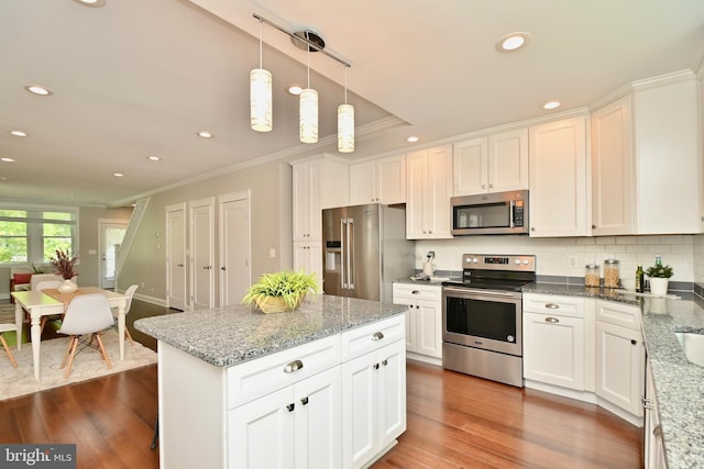 1103 Morse St NE, Washington, DC 20002 - kitchen with appliances with stainless steel finishes, crown molding, recessed lighting, white cabinets, and dark wood-style floors