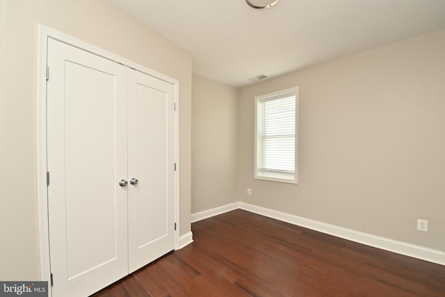 1103 Morse St NE, Washington, DC 20002 - unfurnished bedroom with dark wood-style flooring and a closet