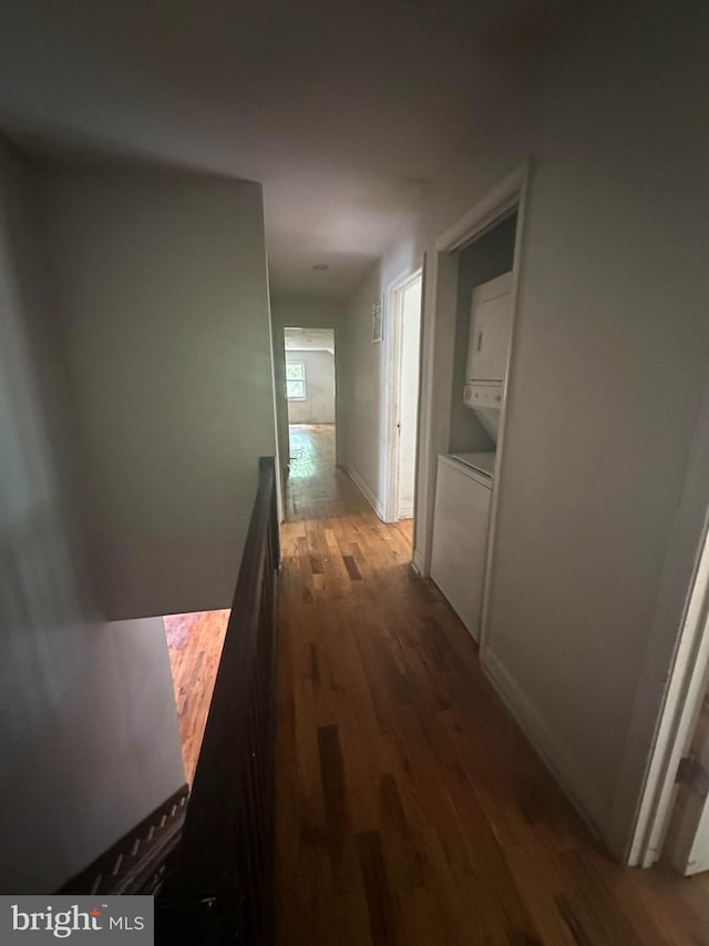 3709 Chesholm Rd, Baltimore, MD 21216 - hallway featuring estacked washer and dryer and wood finished floors