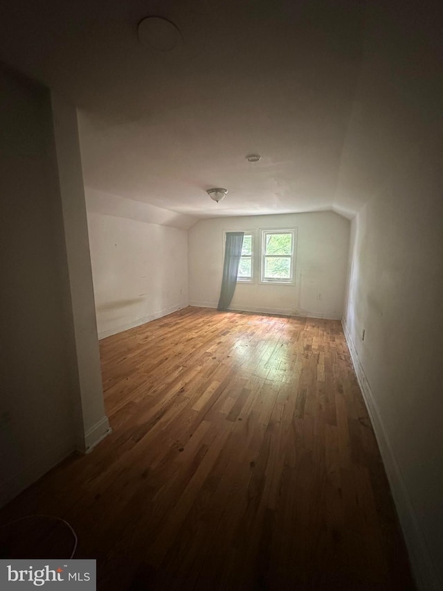 3709 Chesholm Rd, Baltimore, MD 21216 - spare room with wood finished floors and lofted ceiling