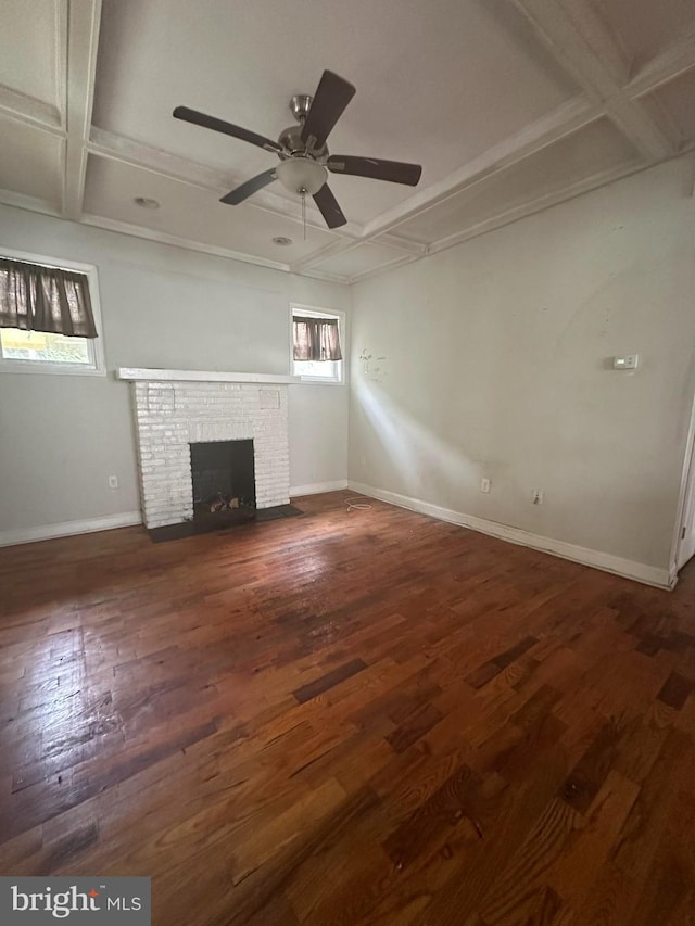 3709 Chesholm Rd, Baltimore, MD 21216 - unfurnished living room with a ceiling fan, a brick fireplace, coffered ceiling, wood finished floors, and beamed ceiling