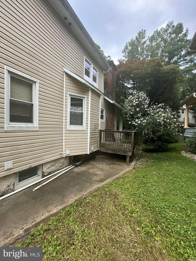 3709 Chesholm Rd, Baltimore, MD 21216 - view of side of property with a yard and a deck