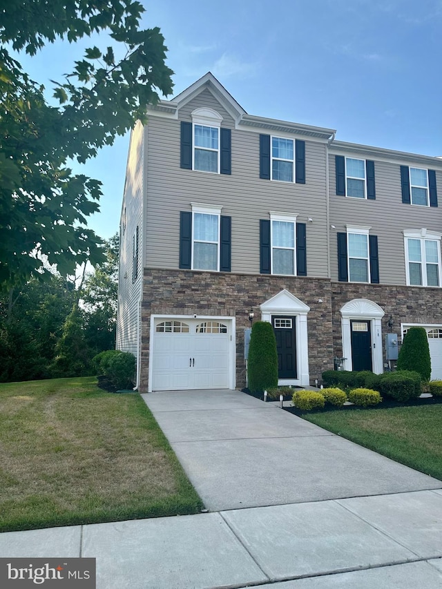 20 Village Green Ln, Sicklerville, NJ 08081 - view of front facade featuring stone siding, an attached garage, concrete driveway, and a front lawn