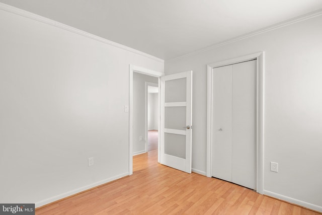 52 Anna Ct Unit 275, Gaithersburg, MD 20877 - unfurnished bedroom with ornamental molding, light wood-style flooring, and a closet
