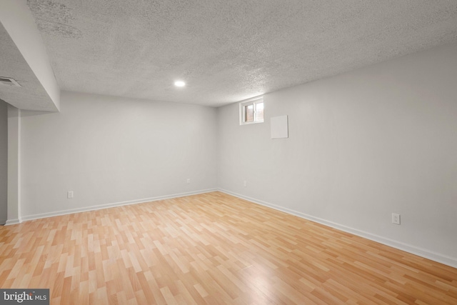 52 Anna Ct Unit 275, Gaithersburg, MD 20877 - basement featuring a textured ceiling and light wood-style flooring