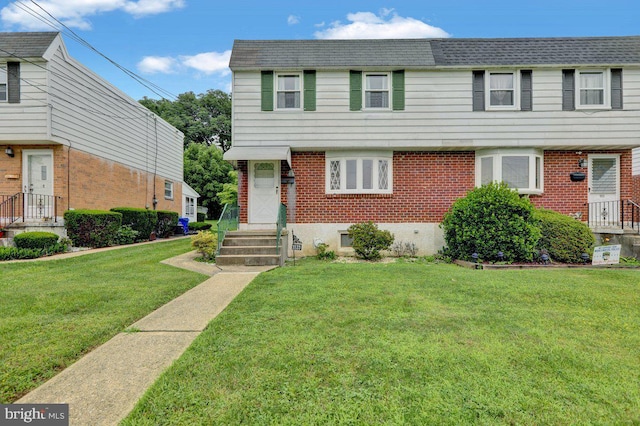 3533 Chestnut St, Reading, PA 19605 - view of front of home featuring brick siding and a front yard