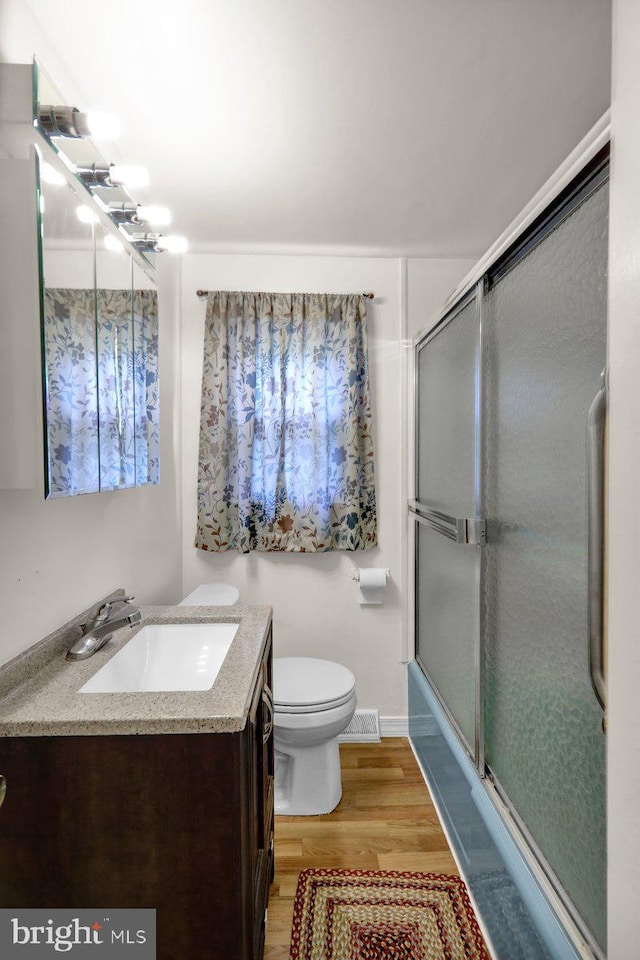 3533 Chestnut St, Reading, PA 19605 - bathroom featuring vanity, wood finished floors, and a shower with door