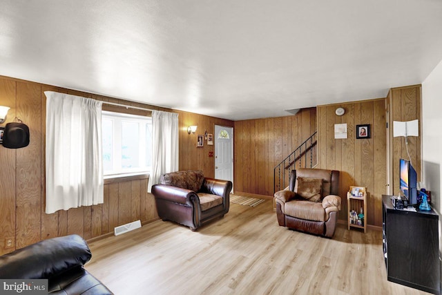 3533 Chestnut St, Reading, PA 19605 - living room with wood finished floors, wooden walls, and stairs