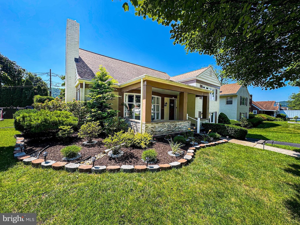 919 Brighton Ave, Reading, PA 19606 - view of property exterior with roof with shingles, a chimney, stone siding, and a porch