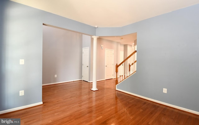 1007 Wright Ct, Fredericksburg, VA 22401 - spare room featuring ornate columns, wood finished floors, and stairs
