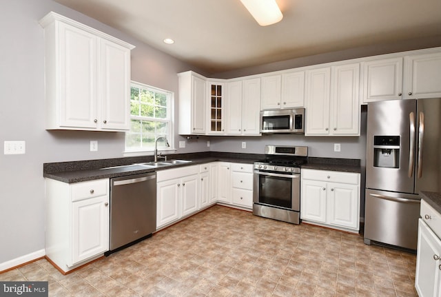 1007 Wright Ct, Fredericksburg, VA 22401 - kitchen with appliances with stainless steel finishes, white cabinetry, glass insert cabinets, recessed lighting, and dark countertops