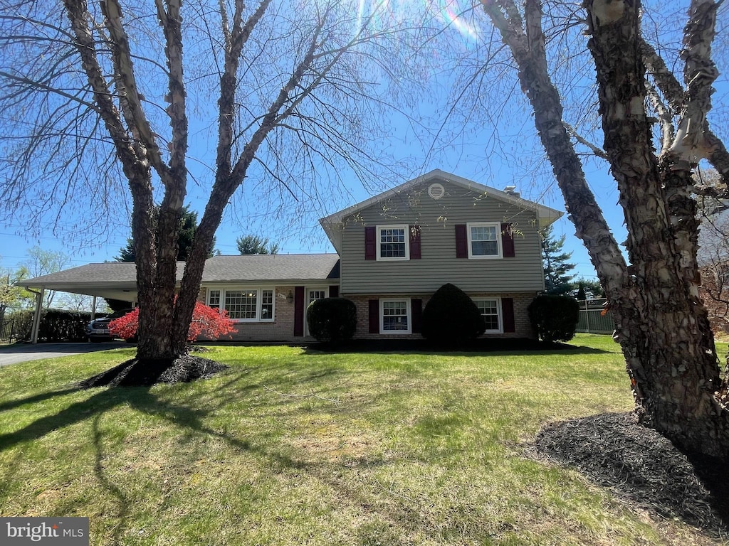 6617 Weaver Ct, Laurel, MD 20707 - tri-level home with brick siding, a front lawn, and a carport