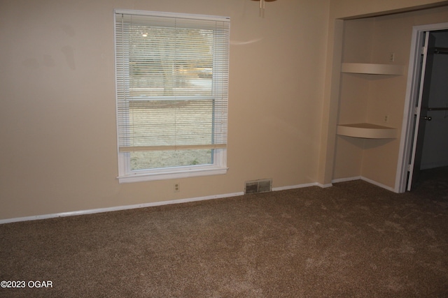 unfurnished bedroom featuring dark colored carpet