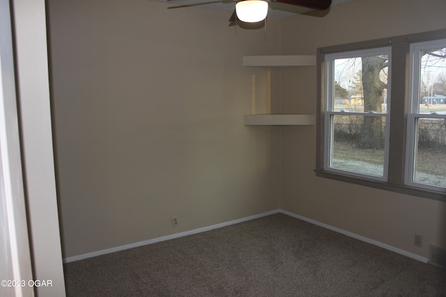 carpeted spare room with ceiling fan