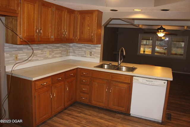 kitchen with ceiling fan, sink, dark hardwood / wood-style flooring, white dishwasher, and tasteful backsplash