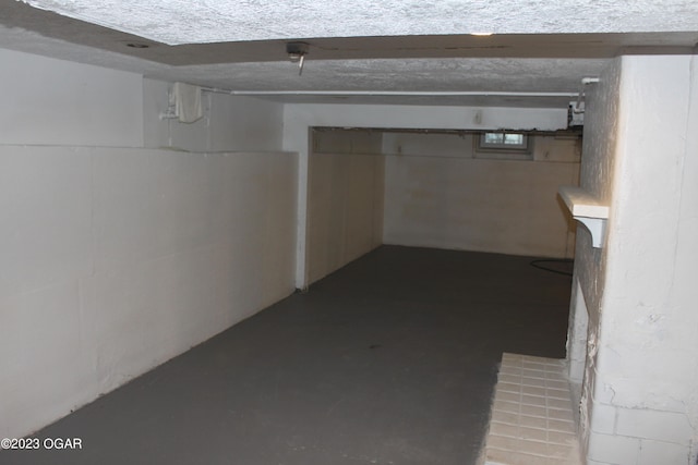 basement featuring a textured ceiling