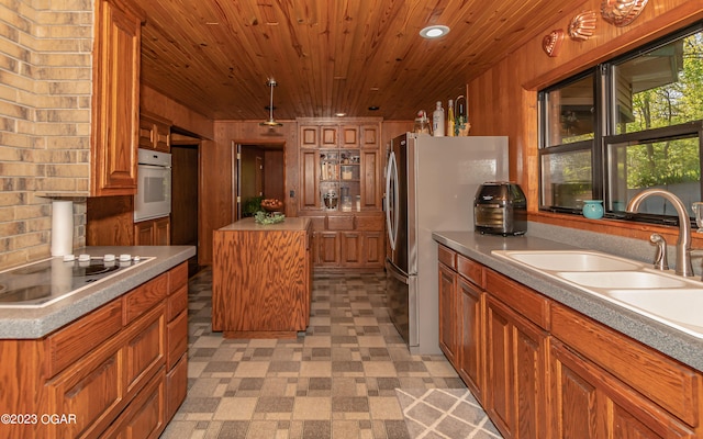 kitchen with light tile flooring, white oven, a kitchen island, electric stovetop, and wooden ceiling