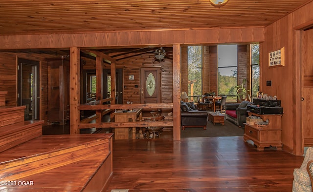 dining area with dark hardwood / wood-style flooring, ceiling fan, wooden ceiling, and wooden walls