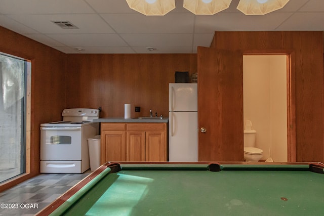 rec room featuring sink, a paneled ceiling, wood walls, and billiards