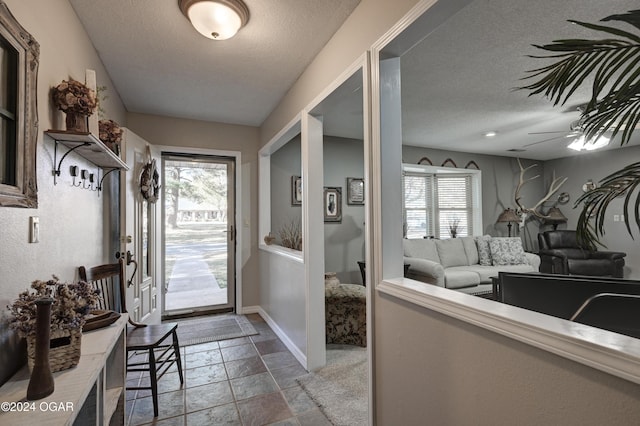 interior space featuring ceiling fan and a textured ceiling