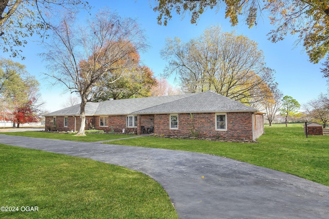 ranch-style home with a front lawn