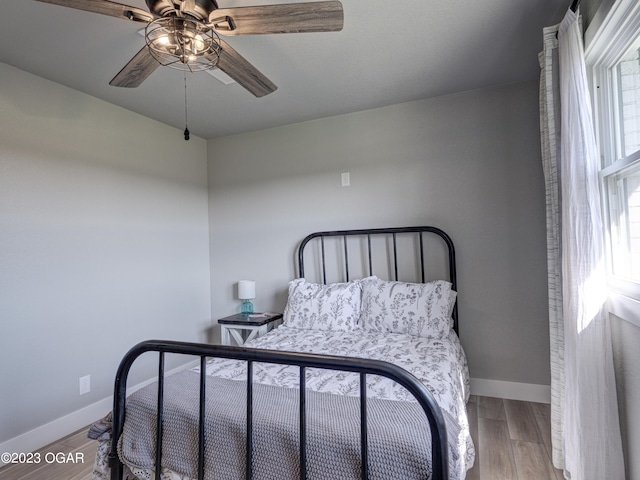 bedroom featuring hardwood / wood-style floors and ceiling fan