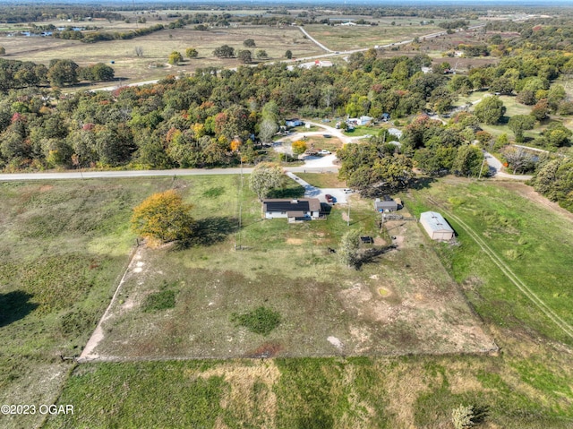 birds eye view of property with a rural view