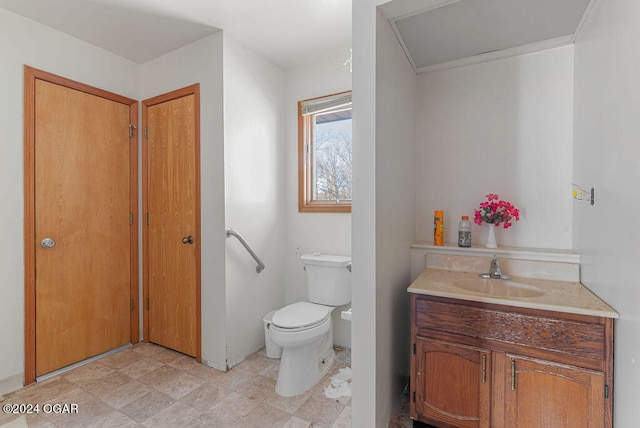 bathroom featuring vanity, toilet, and tile floors