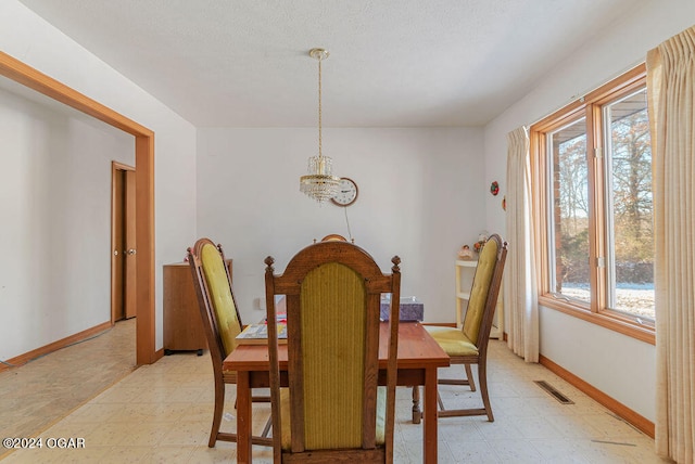 tiled dining space with a notable chandelier and a wealth of natural light