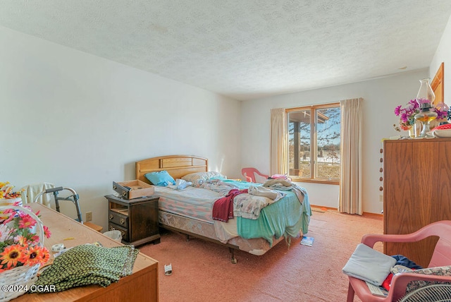 bedroom featuring light carpet and a textured ceiling