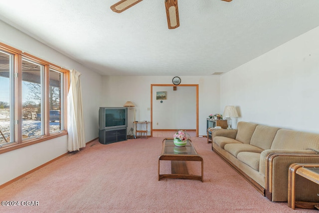 carpeted living room with ceiling fan